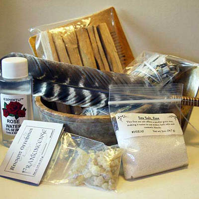 House cleansing and blessing products including sage, palo santo wood, dead sea salt, and rose water